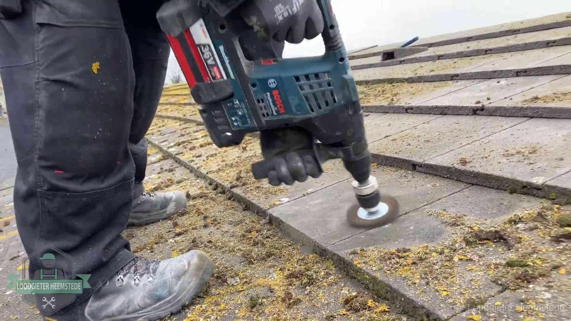 Betonnen dakpannen worden machinaal gereinigd tijdens dakonderhoud in Heemstede