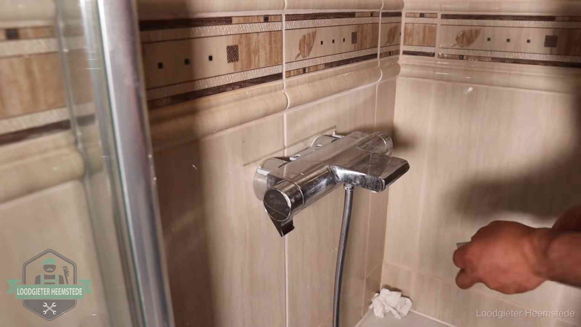Verkalkte douche-mengkraan in Heemstede, hetzelfde kalk dat zich in de warmtewisselaar afzet